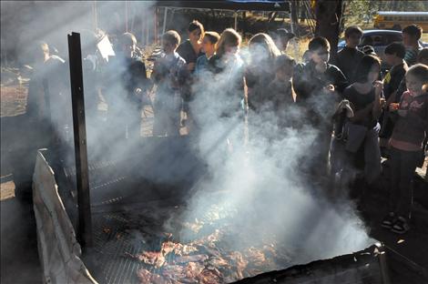 Students eat jerky smoked by volunteers at the People’s Center in a demonstration for Native Heritage Week. 